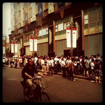 A block-long line of USA visa applicants outside the consular service center, Shanghai